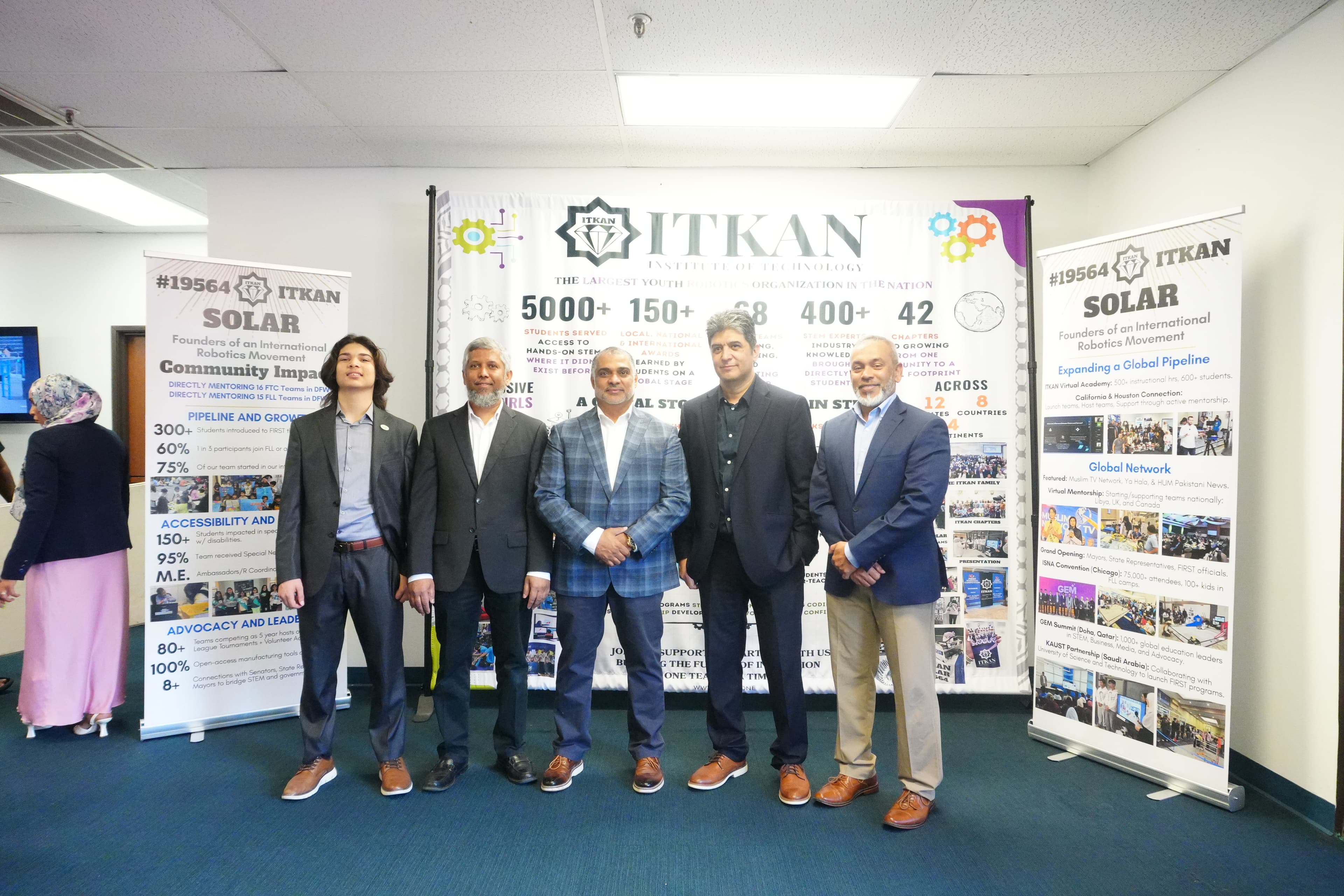 The ITKAN board in front of the ITKAN Institute of Technology banner