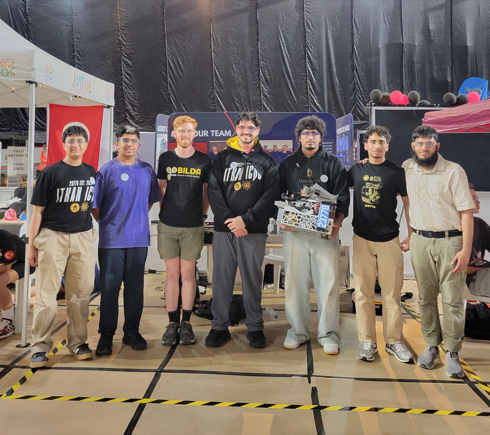 The ITKAN ICQC team poses with their robot at the Istanbul Premier Event