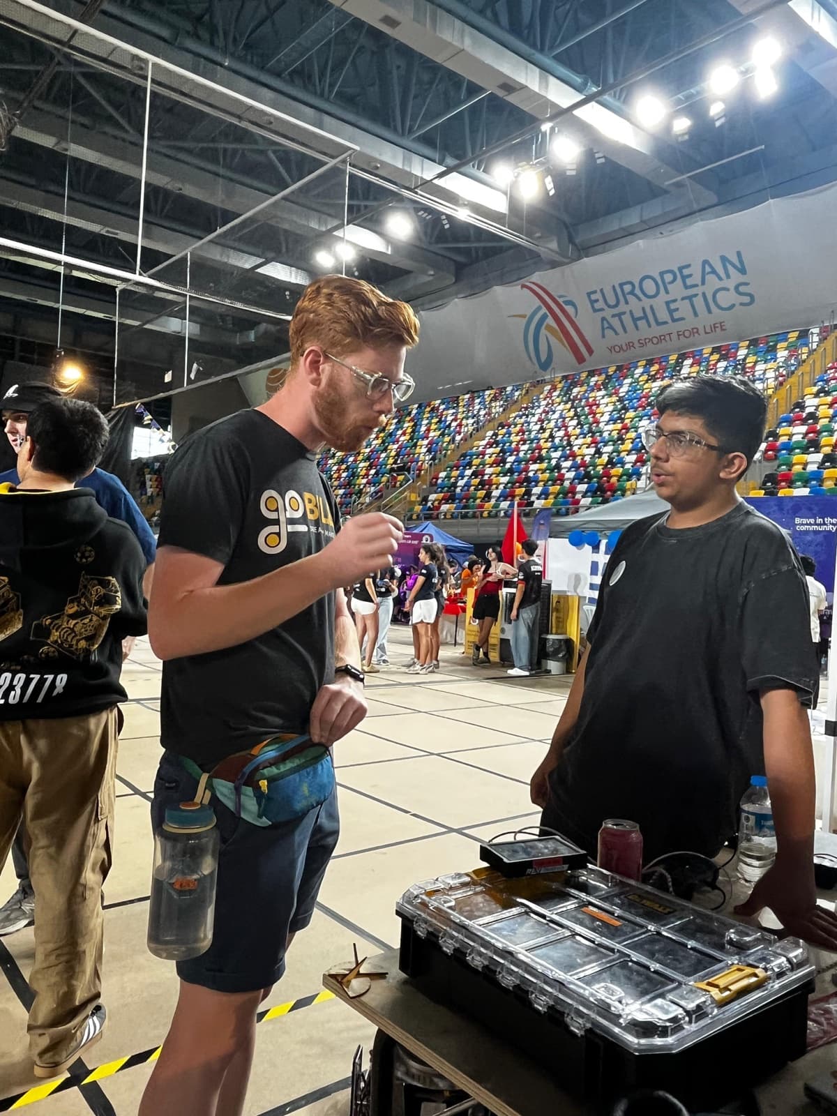 An ITKAN ICQC student coordinates with a member of another team in the pits at the Istanbul venue