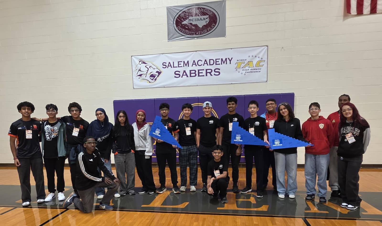 The combined ITKAN North Carolina team poses with FIRST Tech Challenge award pennants at the Carolinas Premier Event