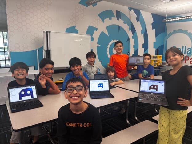 Ma'ruf community students sit at tables around open laptops showing their keychain designs at the ITKAN Innovation Hub