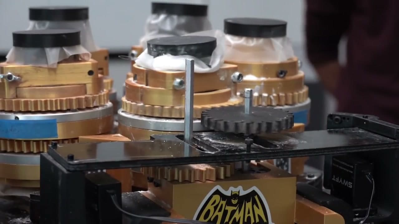 A rotary carousel of powder canisters built to feed one scale in turn
