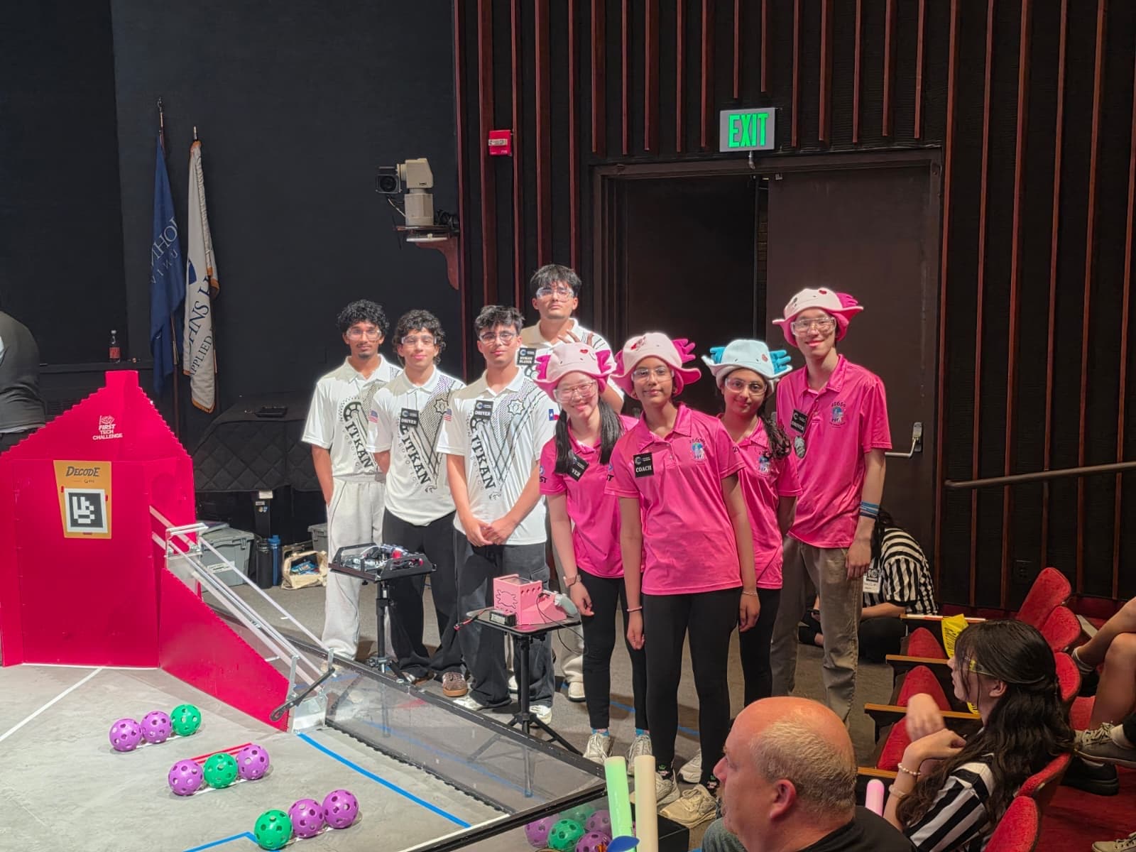 ITKAN Solar (FTC #19564) students gather on the competition stage at the Multinational Tech Invitational, beside the red FTC field
