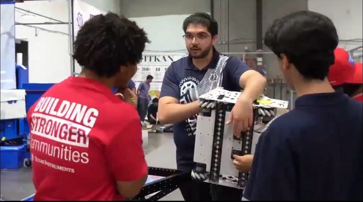 ITKAN student gives a live robot demonstration to a Texas Instruments volunteer at the Innovation Hub, Plano TX