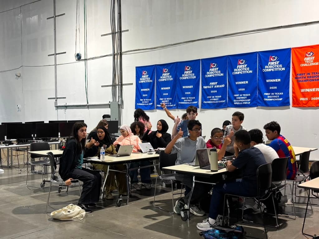Students gather for a training session beneath the team's banner wall.